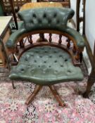 A reproduction buttoned green leather mahogany swivel desk chair, width 62cm, depth 56cm, height