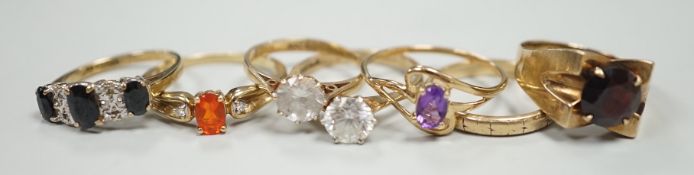 Six assorted modern 9ct gold and gem set rings, including amethyst and garnet single stone rings,