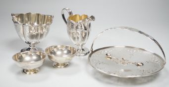 A sterling sugar basket, diameter 9.9cm, a sterling shallow basket dish, sterling cream jug and pair