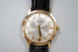 A gentleman's 1970's yellow metal Garrard manual wind wrist watch, with case back inscription, on