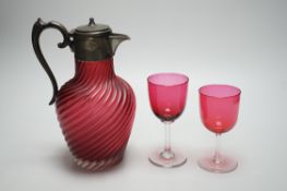 A Victorian wrythen moulded cranberry glass jug, 22cm high, and assorted wine glasses