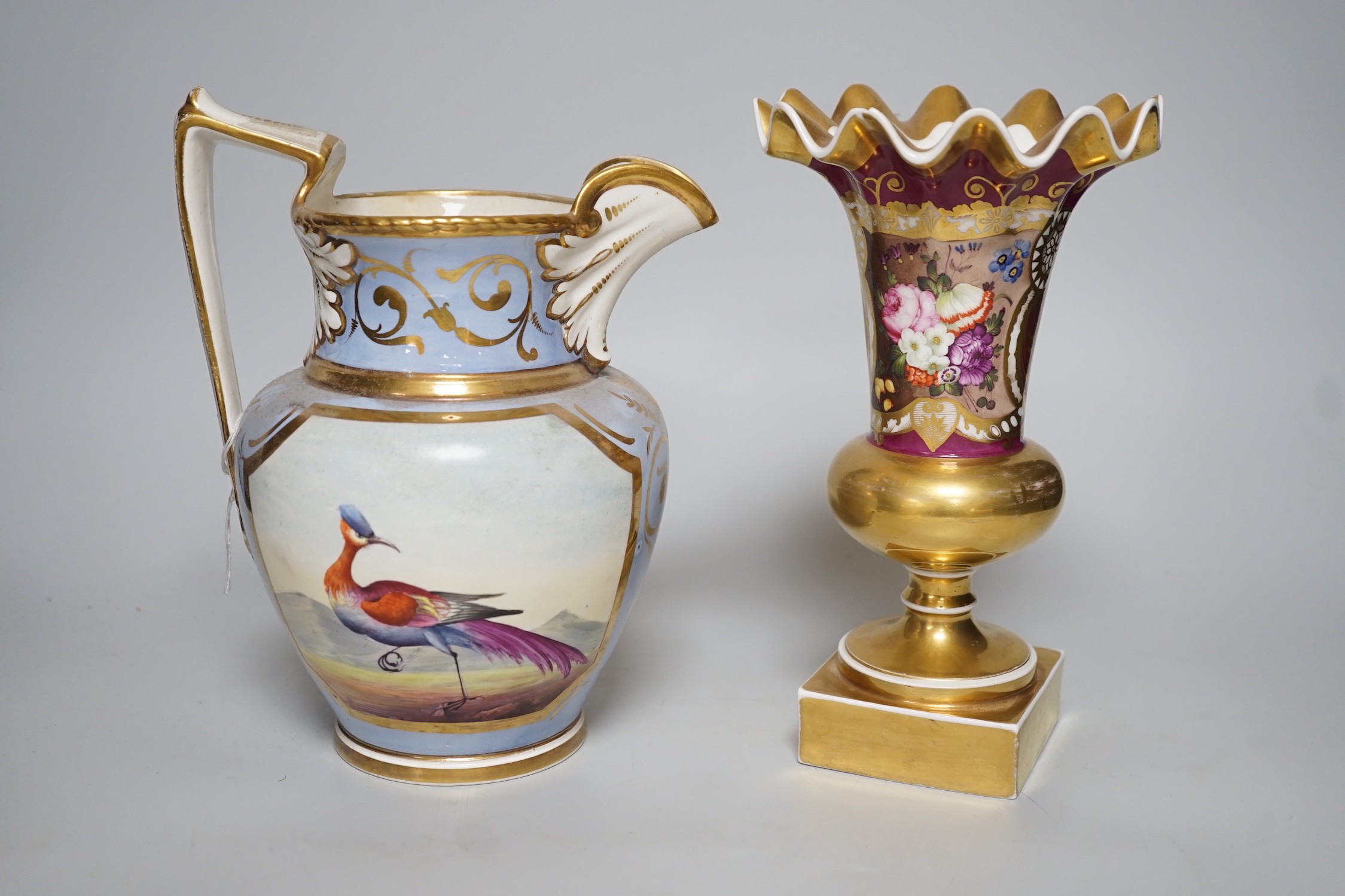 An H & R Daniel jug decorated with exotic birds 22cms high and a floral decorated trumpet vase,