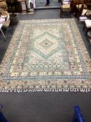 An Afghan pale green ground carpet, 420 x 294cm