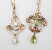 An early 290th century 9ct, peridot and seed pearl set drop pendant, overall 44mm and a similar