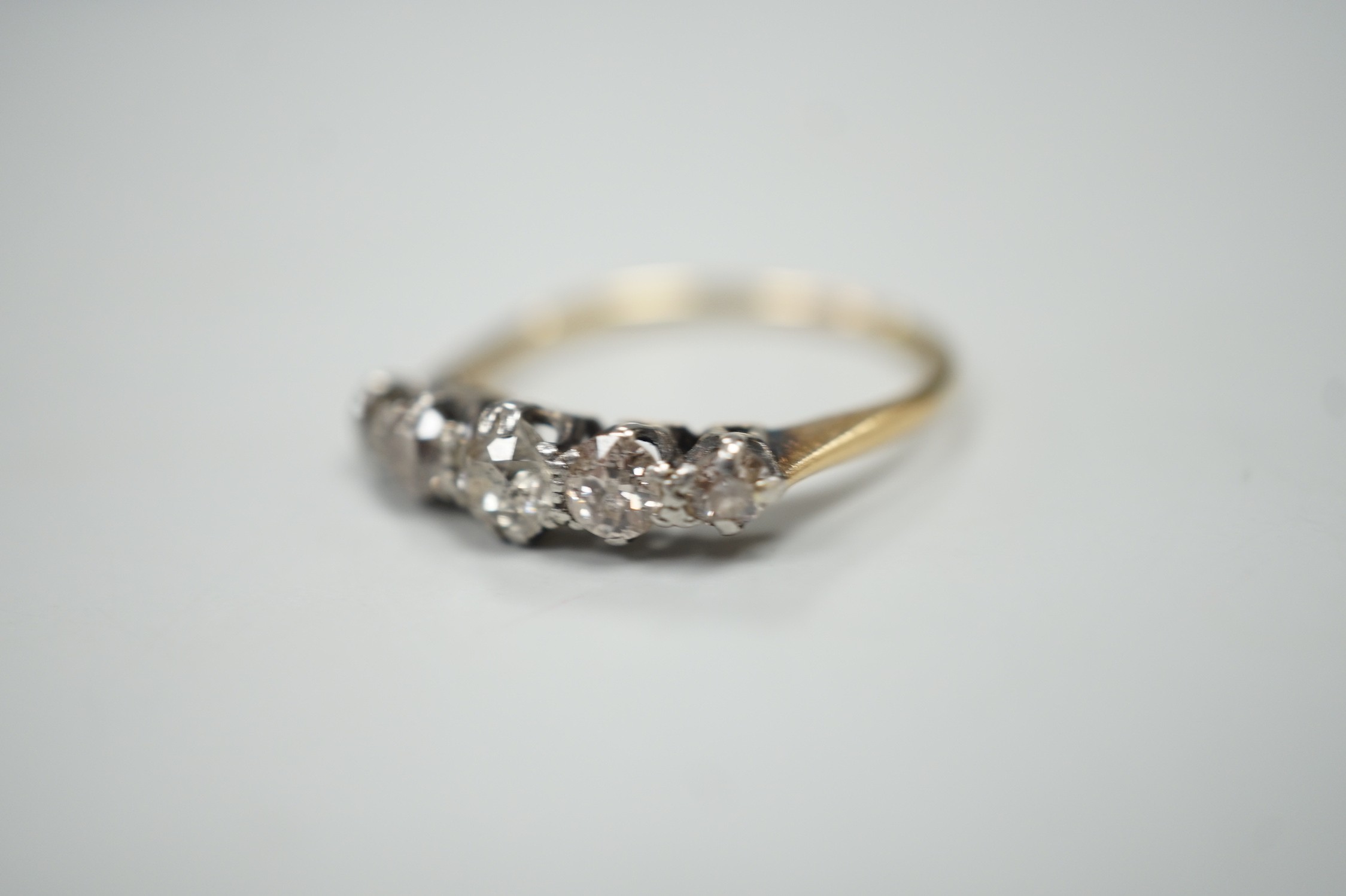 A yellow metal and graduated five stone diamond set half hoop ring, size O, gross weight 2.3 grams. - Image 2 of 4