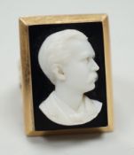 A yellow metal and black sardonyx set rectangular cameo ring, carved with the bust of a gentleman to