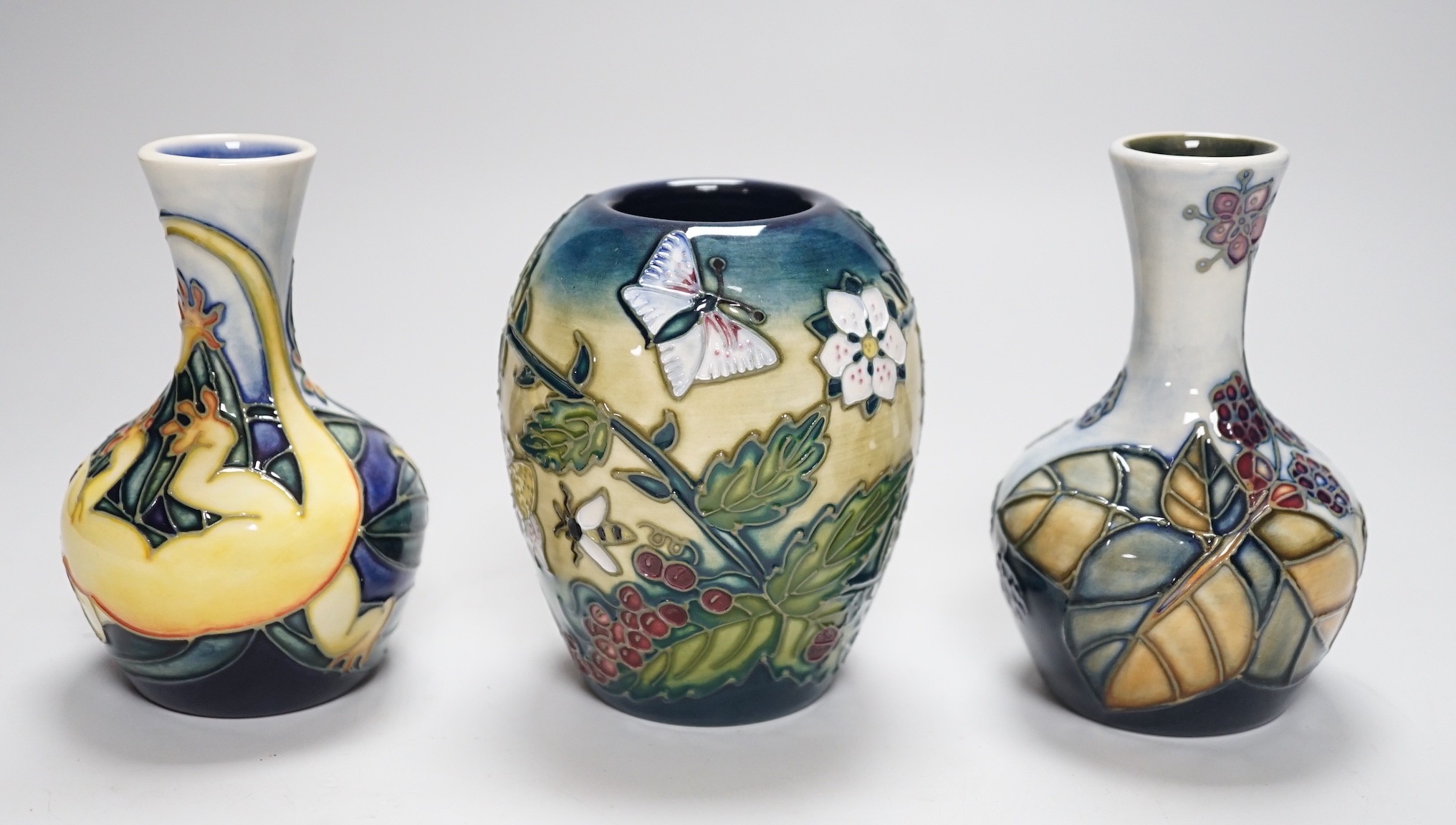 Three boxed Moorcroft small vases, Rarotonga Lizard, Bramble, etc., tallest 10 cm