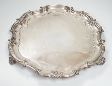 A George V silver salver by Elkington & Co, Birmingham, 1911, of shaped circular form with scroll