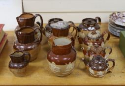 Eight various Royal Doulton Lambeth and other stoneware jugs and tea pots. One silver mounted