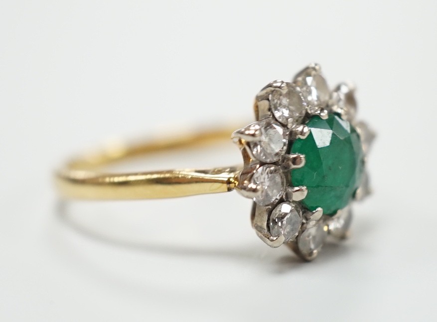 An 18ct, emerald and diamond set circular cluster ring, size K, gross weight 3 grams. - Image 3 of 4