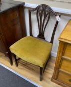 A pair of George III Hepplewhite style mahogany dining chairs, with stuff-over seats, on square