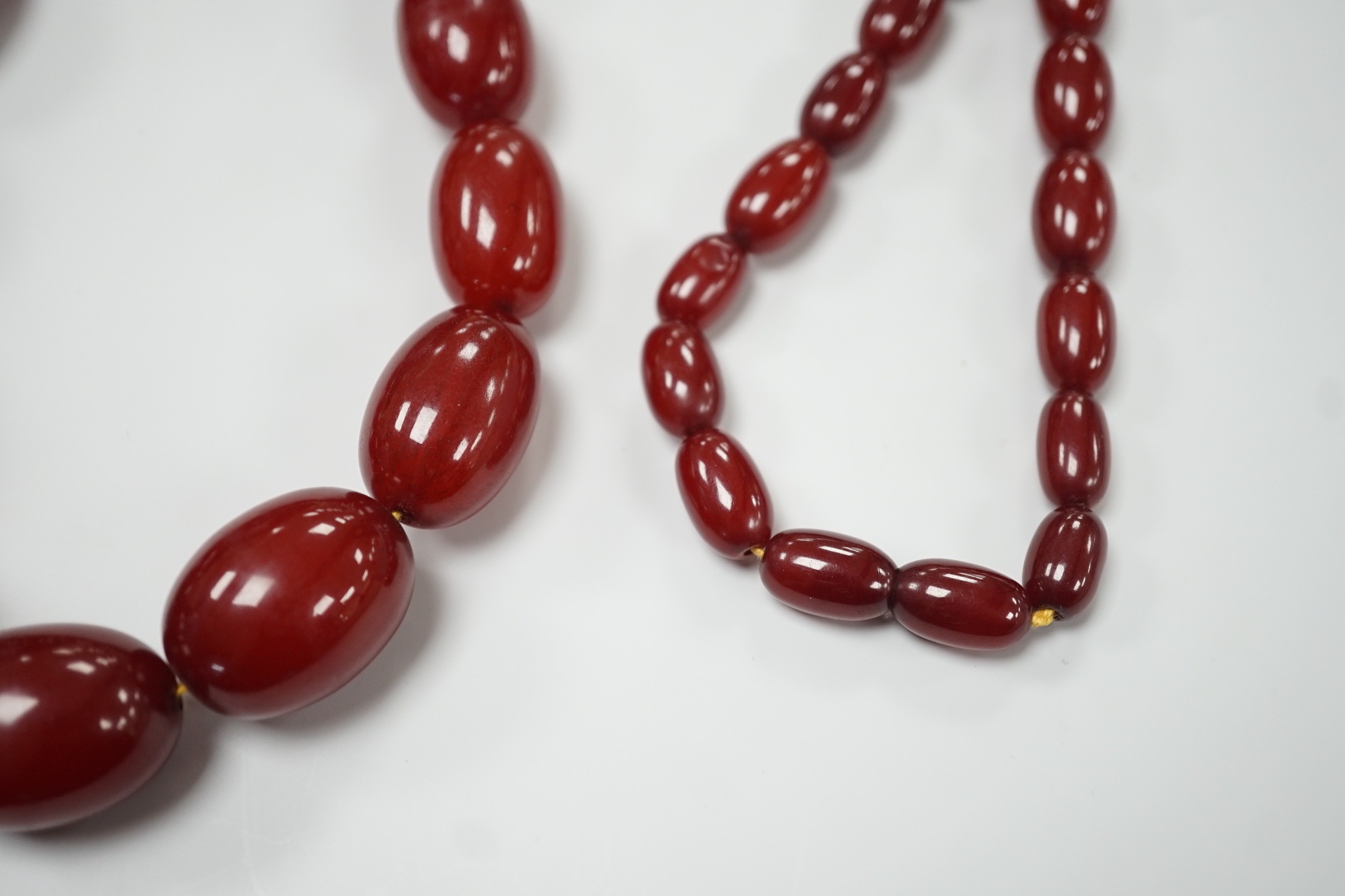 A single strand graduated simulated oval cherry amber necklace, 82cm, gross weight 113 grams. - Image 3 of 4