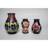 Three boxed Moorcroft vases of varying shapes, tallest 14cms high