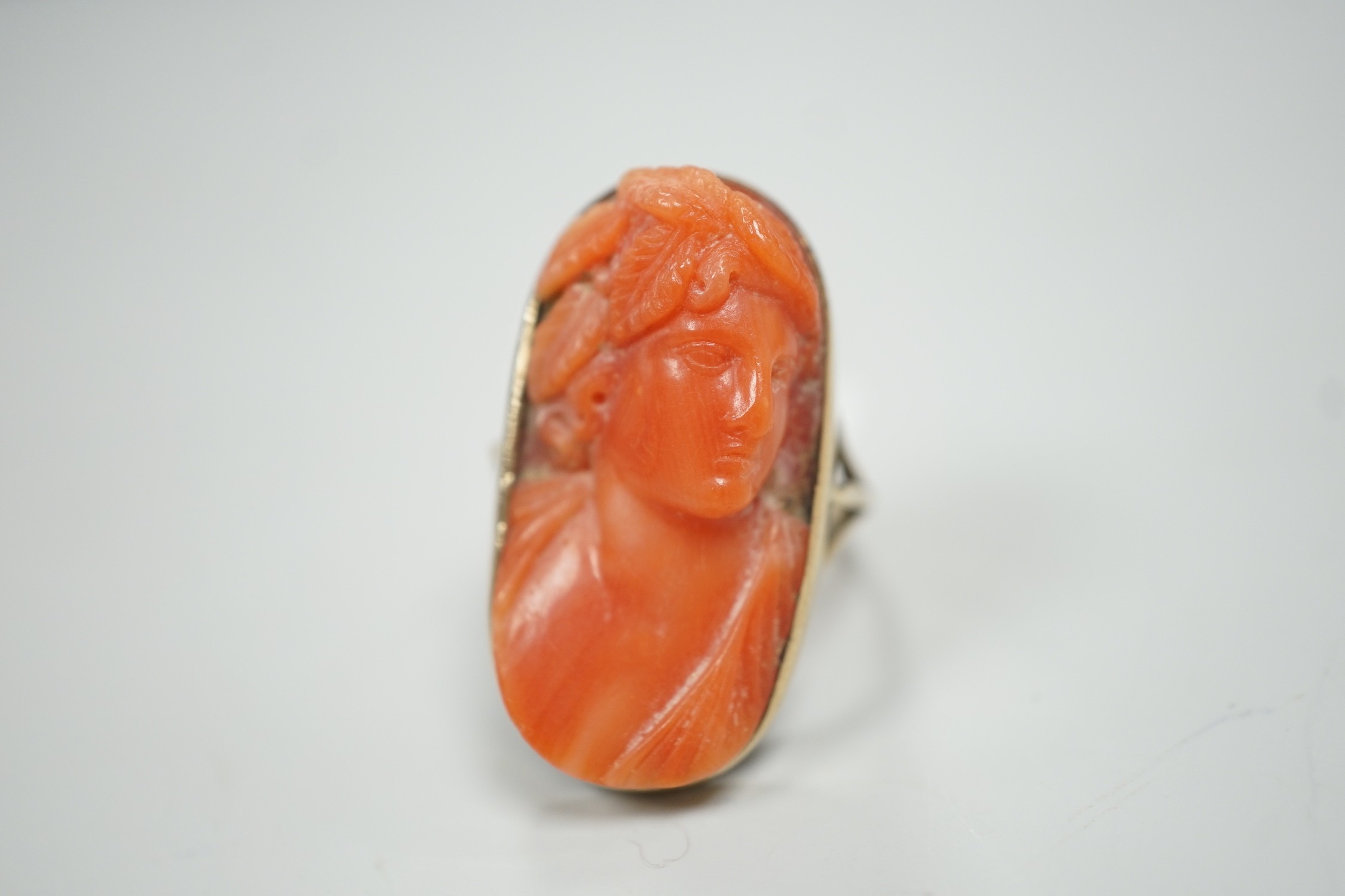 A yellow metal and coral set oval dress upfinger ring, the coral carved with a classical bust to - Image 3 of 6