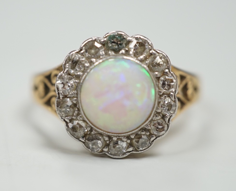 A 1920's? yellow metal, white opal and round cut diamond set circular cluster ring, size O, gross