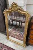 A 19th century French giltwood and composition wall mirror with floral shell pediment, width 90cm,