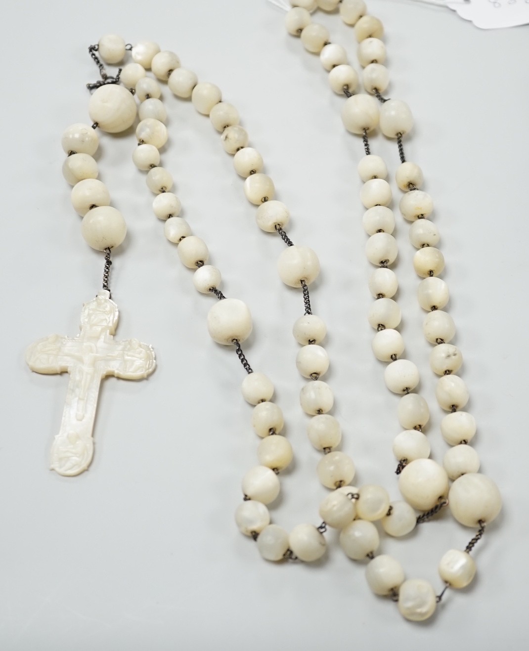 A long mother of pearl multi bead necklace, 158cm, with carved mother of pearl crucifix pendant, - Image 5 of 8