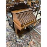 A 1920's oak roll top bureau with 'S' shaped tambour, width 69cm, depth 46cm, height 102cm