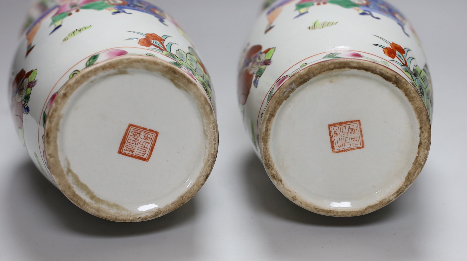 A pair of Chinese Famille Rose ‘boys’ vases, 25cms high - Image 5 of 5