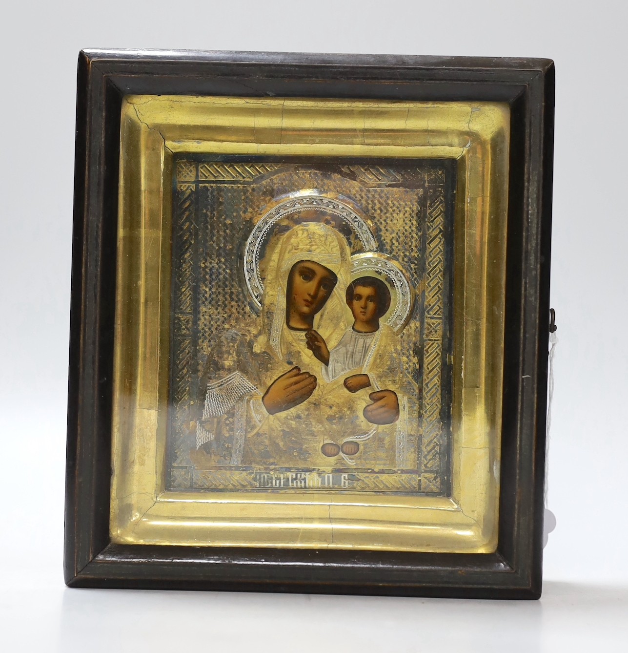 A 20th century Russian painted wood icon of Madonna and Child, with silver-gilt oklad, in gilt