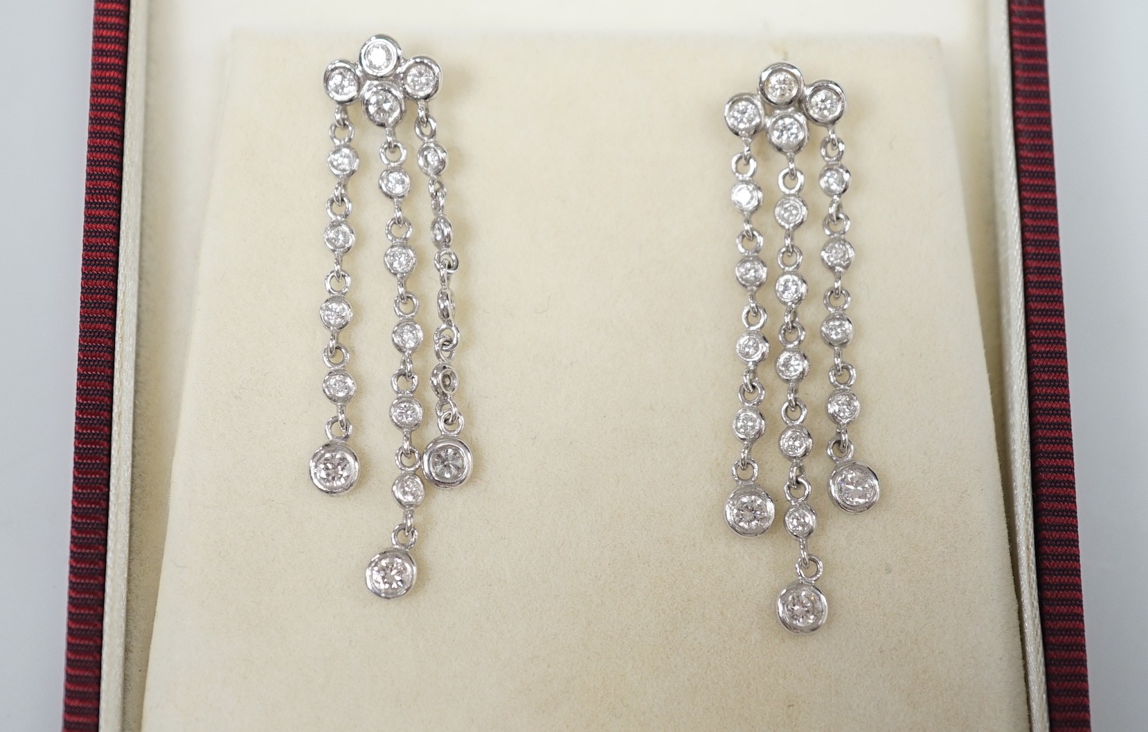 A modern pair of 750 white metal and diamond cluster set drop earrings, 42mm, gross weight 5.2