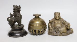 A Chinese bronze seated figure of Budai and tiger together with an Indian elephant bell and a