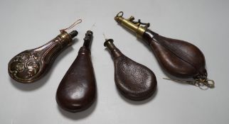 Four brass mounted powder flasks, to include three leather flasks, and one copper. Largest 24cm