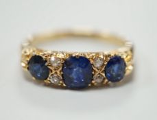 A George V 18ct gold and three stone sapphire set half hoop ring, with four diamond chip spacers,