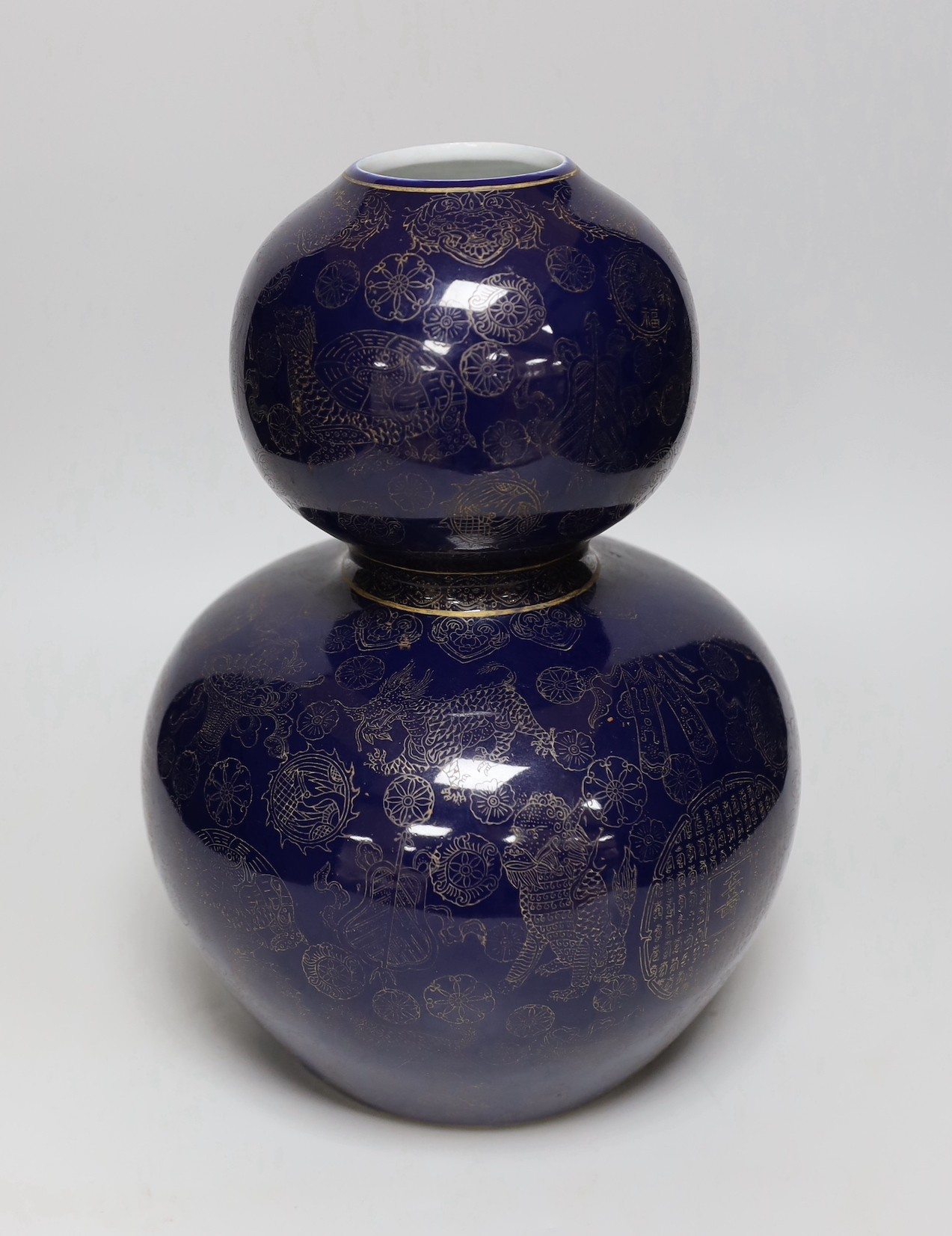 A large Chinese gilt decorated blue glazed double gourd vase, 31cm