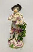 A Derby porcelain figure, emblematic of Autumn, modelled as a boy holding grapes and vine, 18th