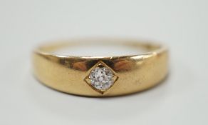 An early 20th century 18ct gold and gypsy set solitaire diamond ring, size M, gross weight 3.2