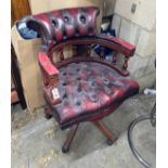 A reproduction buttoned burgundy leather swivel desk chair, width 60cm, depth 54cm, height 84cm