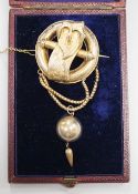 A Victorian gilt white metal drop brooch, with central buckle motif and spherical drop, 80mm, in