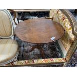 A George III oak circular tilt top tea table, diameter 82cm, height 72cm