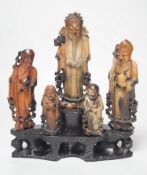 An early 20th century Chinese carved soapstone group of five deities on a rockwork base, 23cm