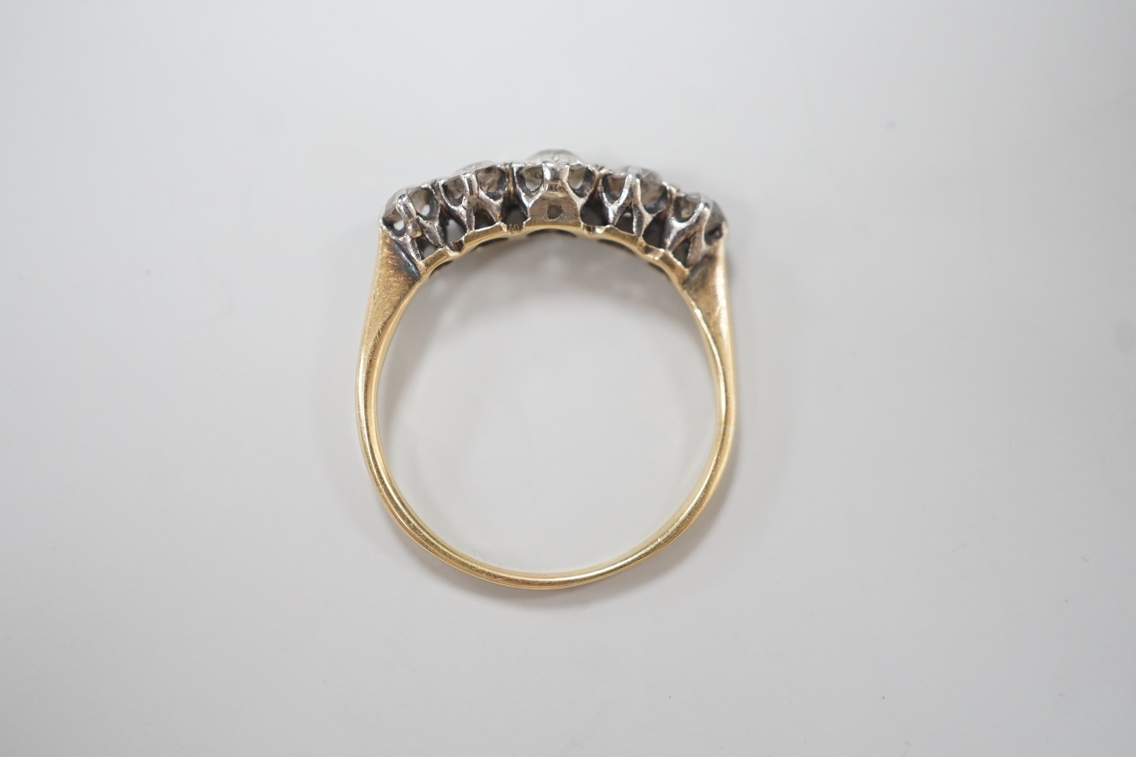 A yellow metal and graduated five stone diamond set half hoop ring, size O, gross weight 2.3 grams. - Image 4 of 4