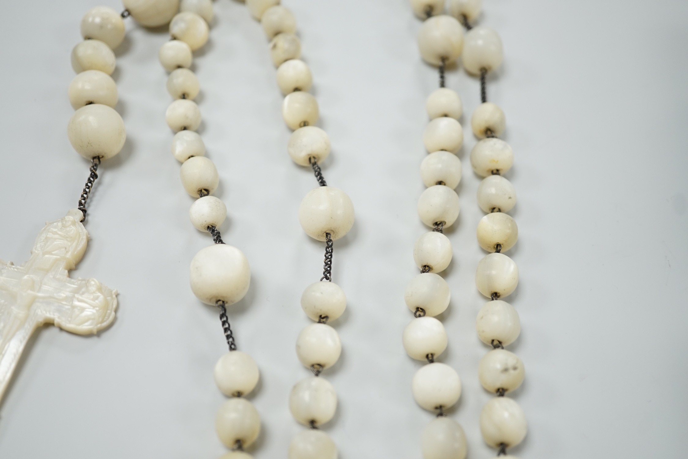 A long mother of pearl multi bead necklace, 158cm, with carved mother of pearl crucifix pendant, - Image 7 of 8