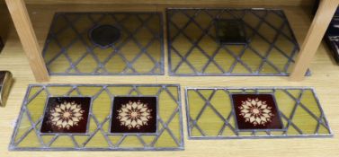 Four late 19th century leaded and stained glass panels, various sizes, with central cartouche