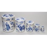 A set of four 19th century Chinese graduated blue and white jars and covers and a small jar with