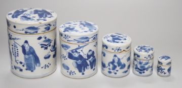 A set of four 19th century Chinese graduated blue and white jars and covers and a small jar with