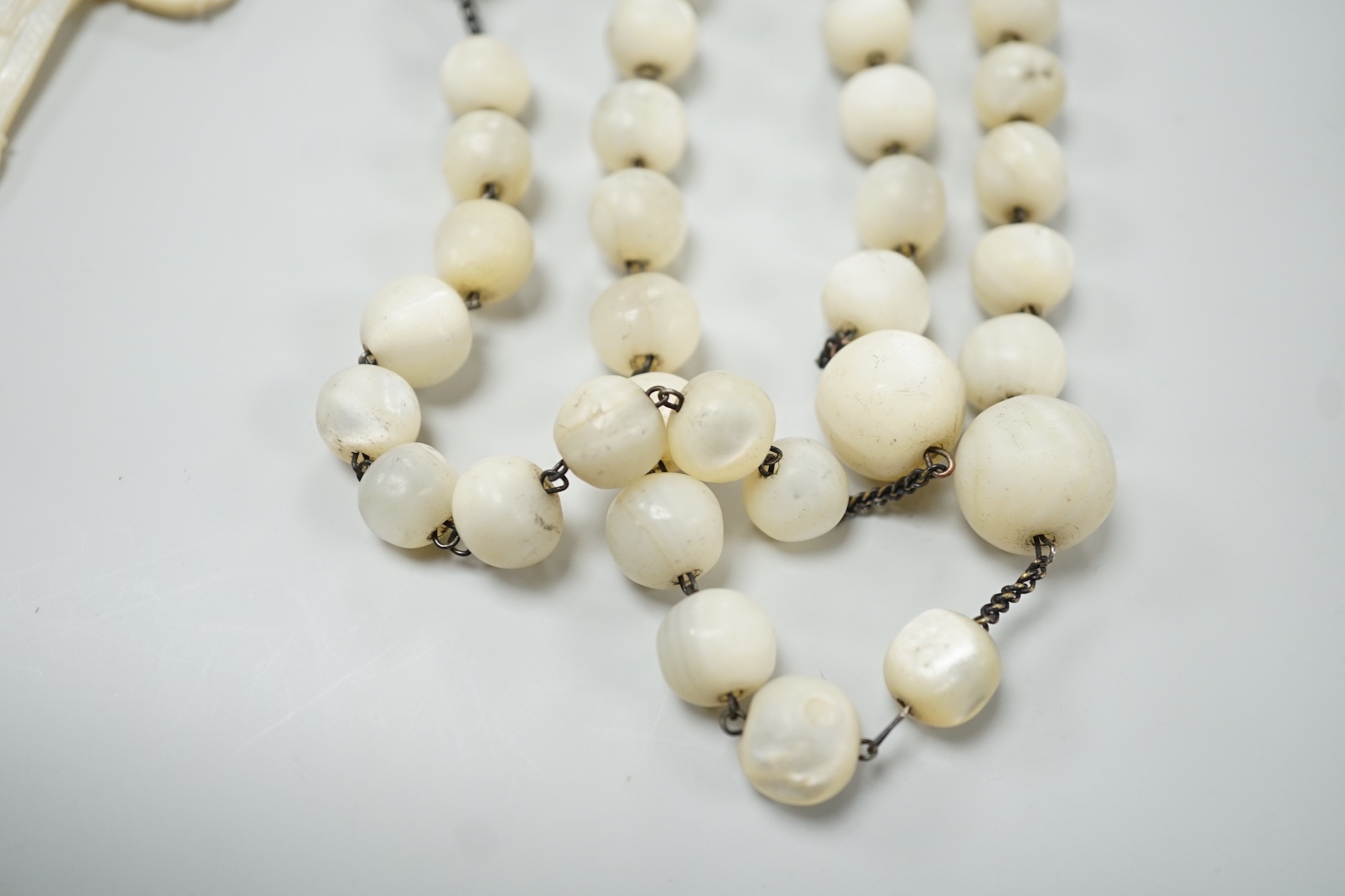 A long mother of pearl multi bead necklace, 158cm, with carved mother of pearl crucifix pendant, - Image 8 of 8