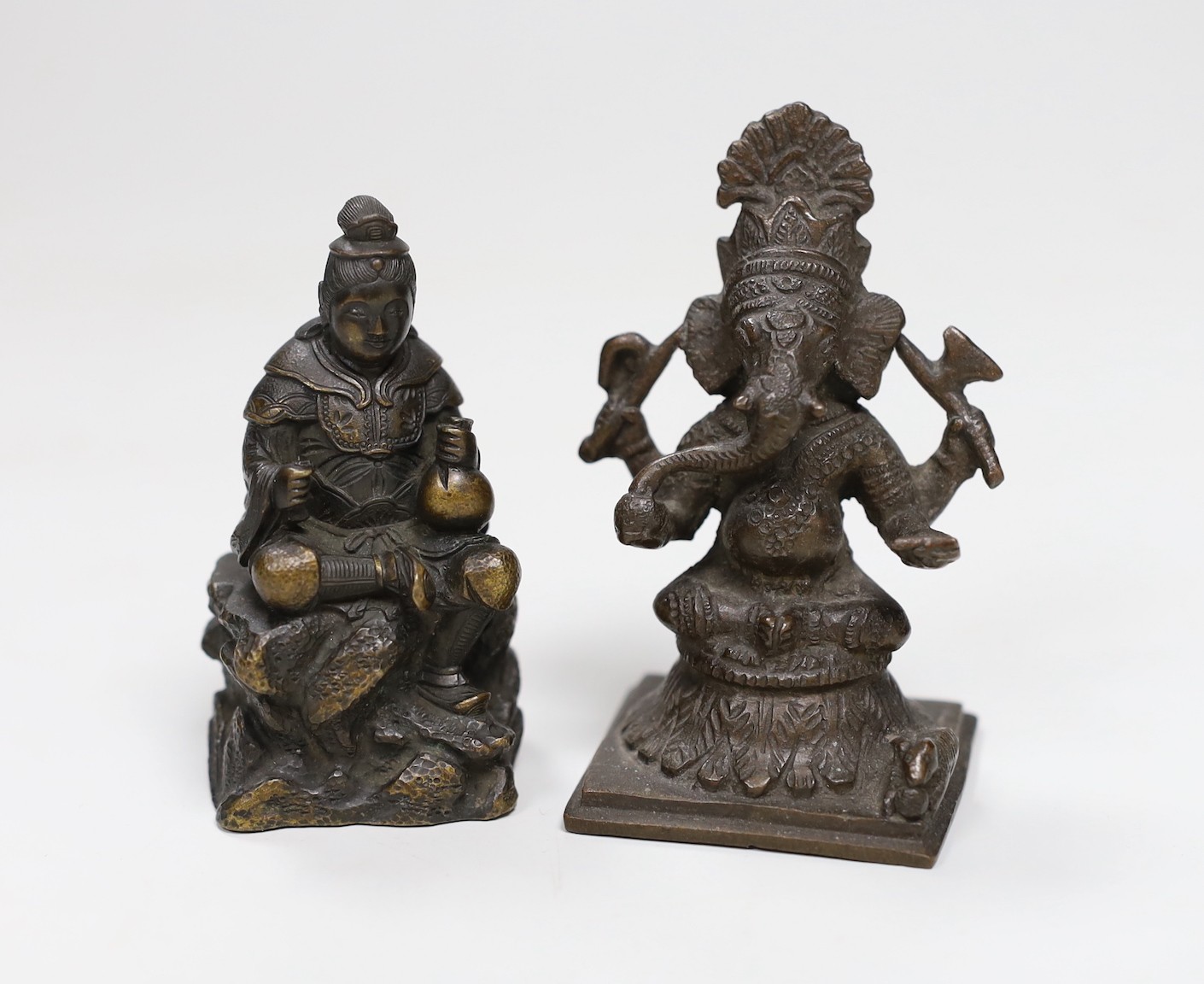 A Japanese Meiji period bronze of a seated figure, inscription to base together with an Indian