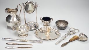 A 1920's silver mounted manicure stand with mirror and three associated implements, a small silver