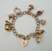 A 9ct gold oval link charm bracelet, hung with ten assorted charms including nine 9ct gold, gross