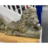 A large reconstituted stone recumbent lion garden ornament, length 91cm, depth 33cm, height 60cm