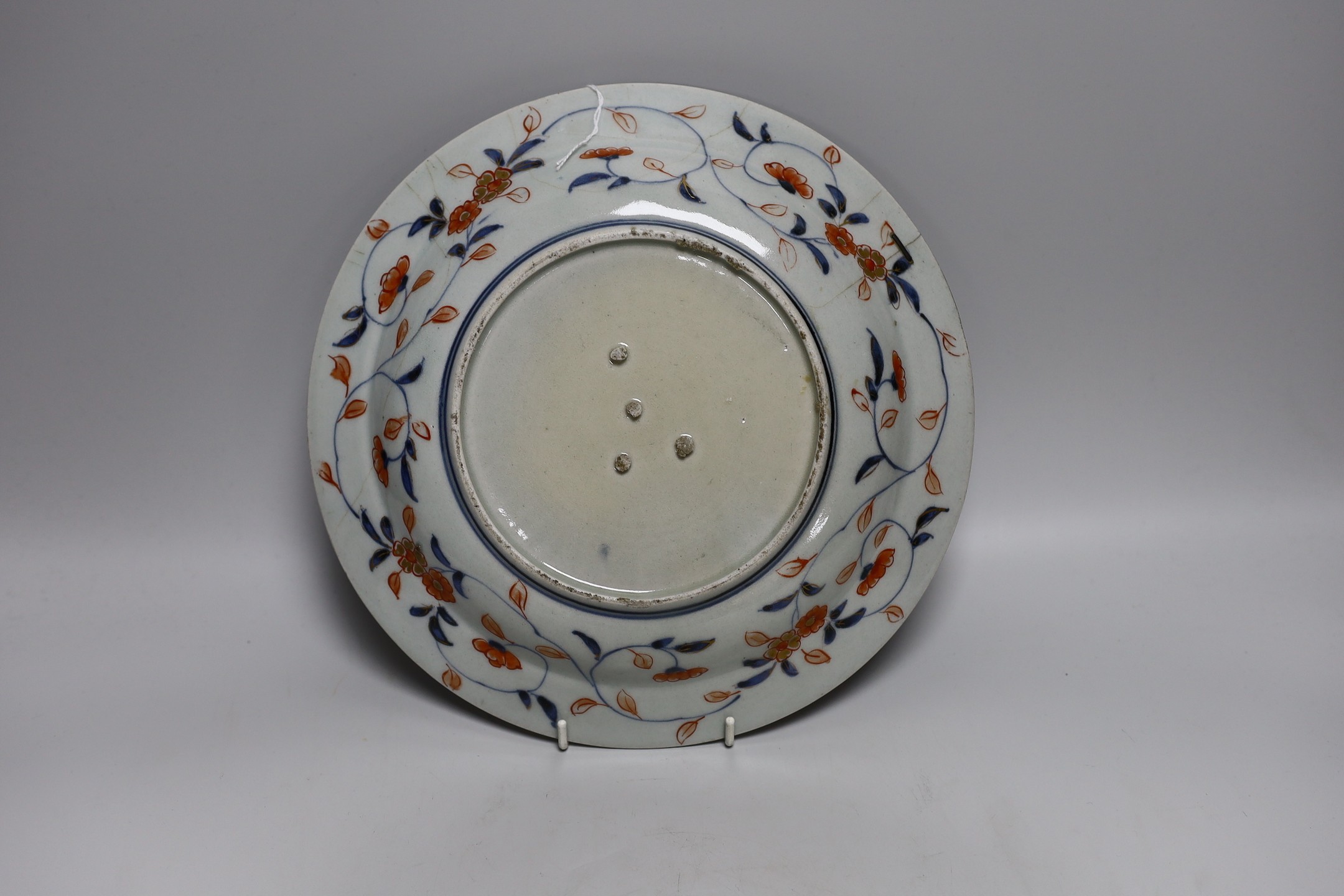 A Japanese Arita dish, late 17th century, painted in Imari palette, stilt marks, cracked, 28cms - Image 3 of 4
