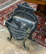 A cast iron and brass serpentine fire grate, width 46cm, depth 29cm, height 66cm