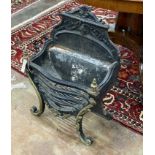 A cast iron and brass serpentine fire grate, width 46cm, depth 29cm, height 66cm