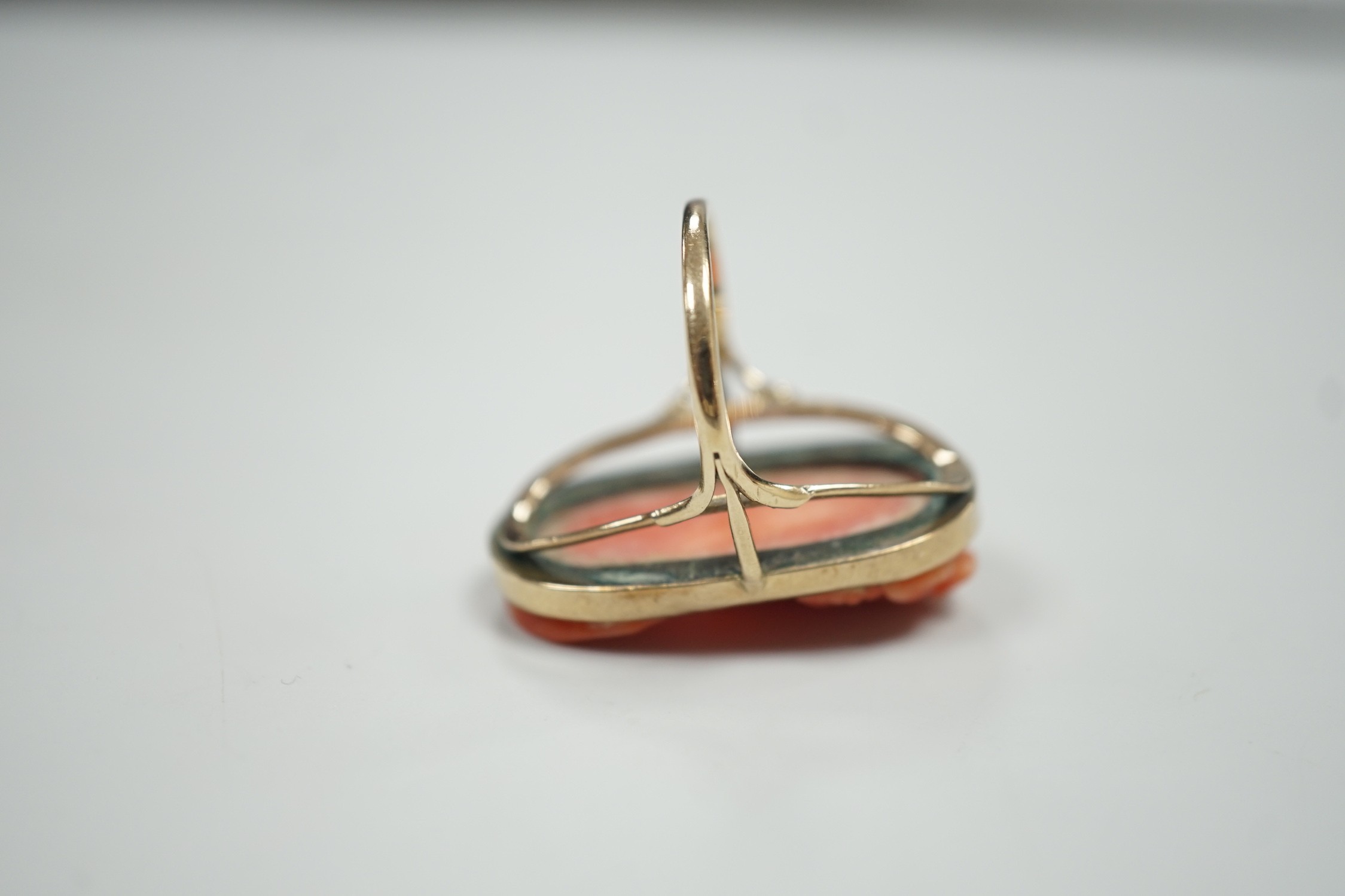 A yellow metal and coral set oval dress upfinger ring, the coral carved with a classical bust to - Image 6 of 6