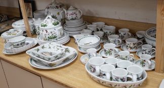 A mixed Portmerion dinner service- a biscuit jar and cover, tureens, serving dishes, teapot etc